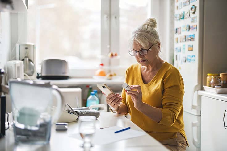 Woman Checking Medication Dosage On Phone